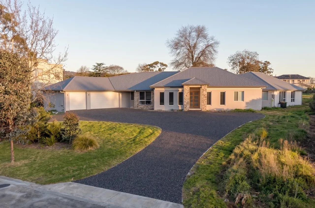 New exposed aggregate driveway at golden hour in front of a modern Melbourne home